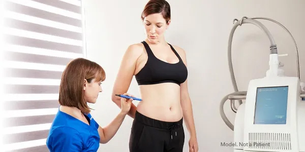 Doctor prepping patient for CoolSculpting treatment